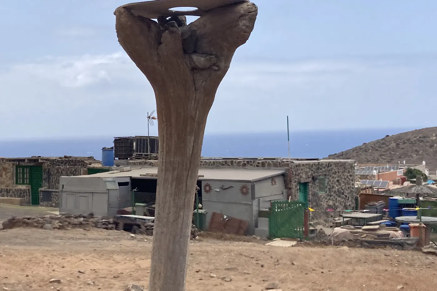 Wooden post planted near the houses of the Cofete hamlet, by the sea