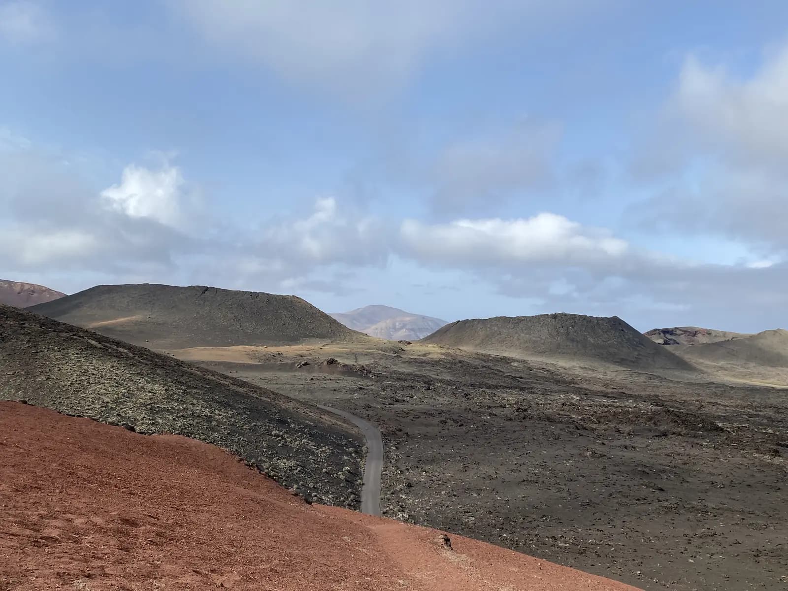 Road crossing the volcanic landscape of Timanfaya National Park in Lanzarote